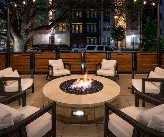 a fire pit is set up on a patio at night at The Ash at  Branch