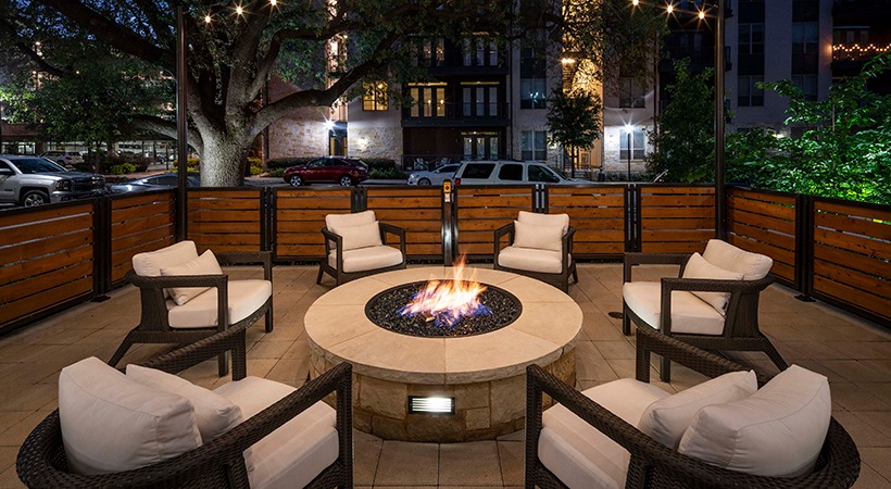 a fire pit is set up on a patio at night at The Ash at  Branch