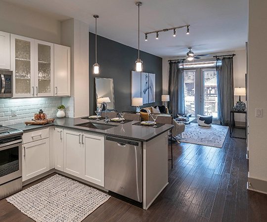 a kitchen with stainless steel appliances and a white counter top at The Ash at  Branch