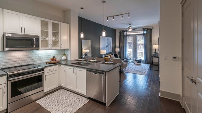 a kitchen with stainless steel appliances and a white counter top at The Ash at  Branch