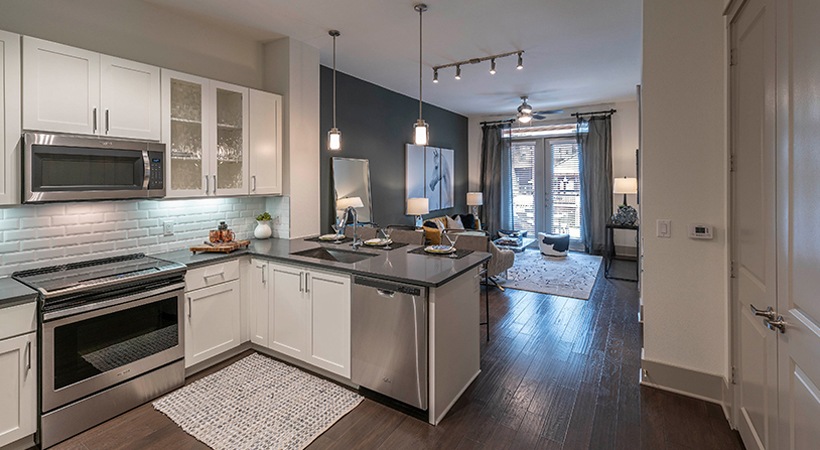 a kitchen with stainless steel appliances and a white counter top at The Ash at  Branch