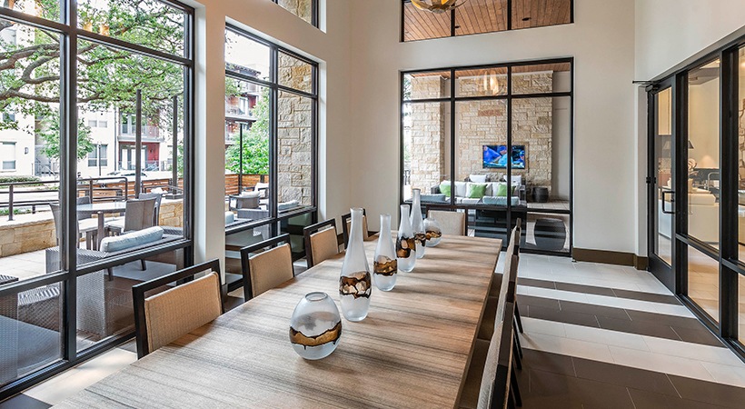 a dining room with large windows and a large table at The Ash at  Branch